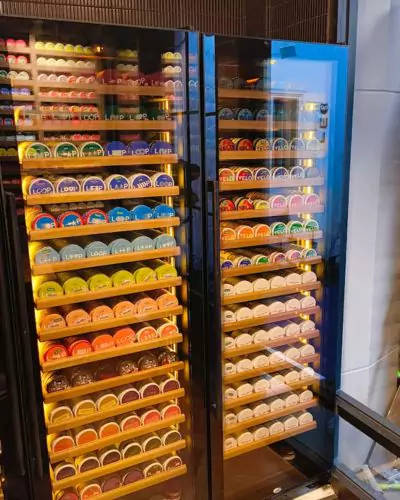 Inside view of a refrigerated display with a wide variety of snus products at a retail store in Bangkok.